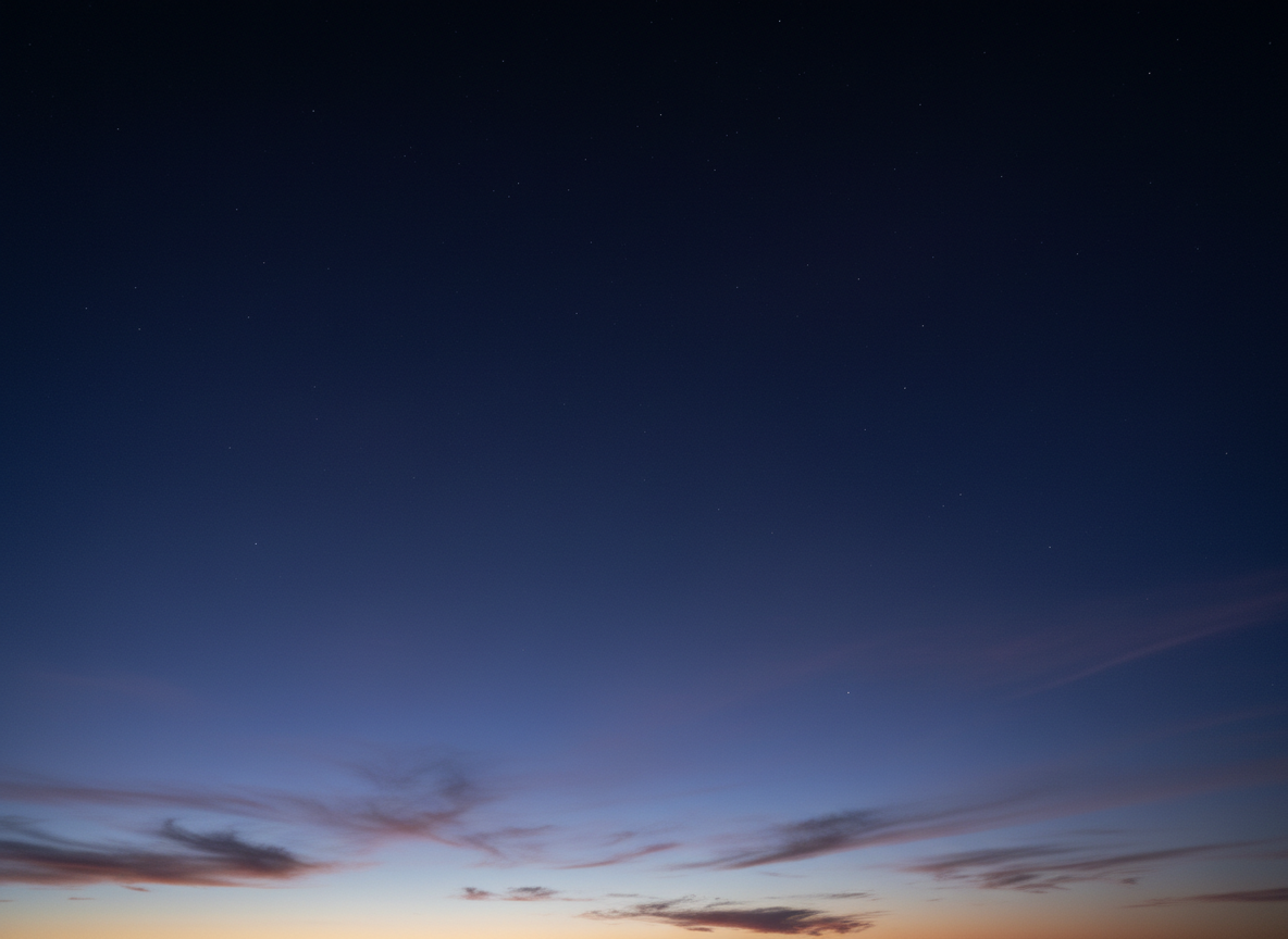 Cinematic wide photograph of a Colorado mountain landscape at blue hour, deep navy blue tones, snow-dusted peaks fading into twilight sky