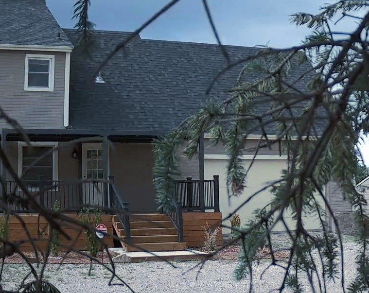 Berglind Rd. property front entry framed by pine branches